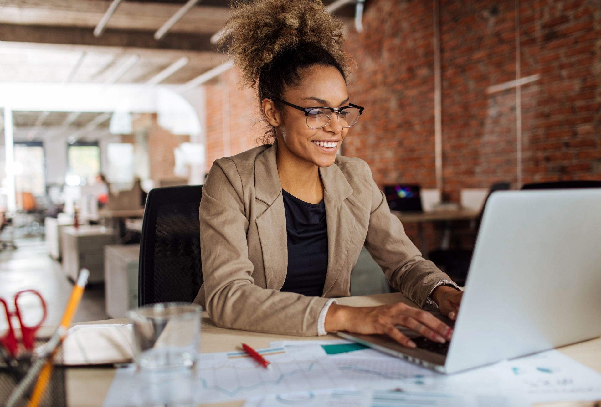 A team member working at a laptop in an open office